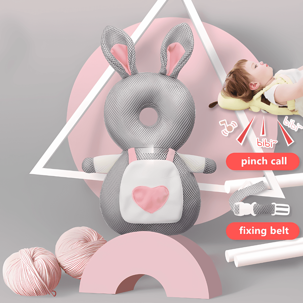 A "Protection Backpack" shaped like a gray and white bunny with pink heart detailing and bunny ears is prominently displayed in the image. A baby sleeps on a bed in the background. The scene includes yarn balls, a crescent shape, and infographic overlays highlighting features such as the pinch call and fixing belt, emphasizing its adorable design for babies.